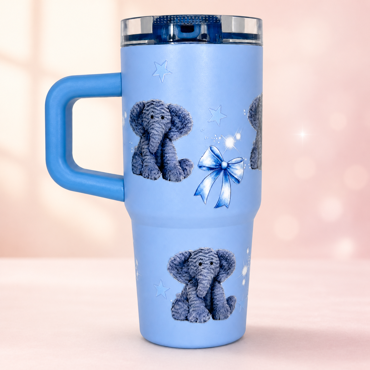 Powder-blue handled tumbler with elephant, bow and star decorations