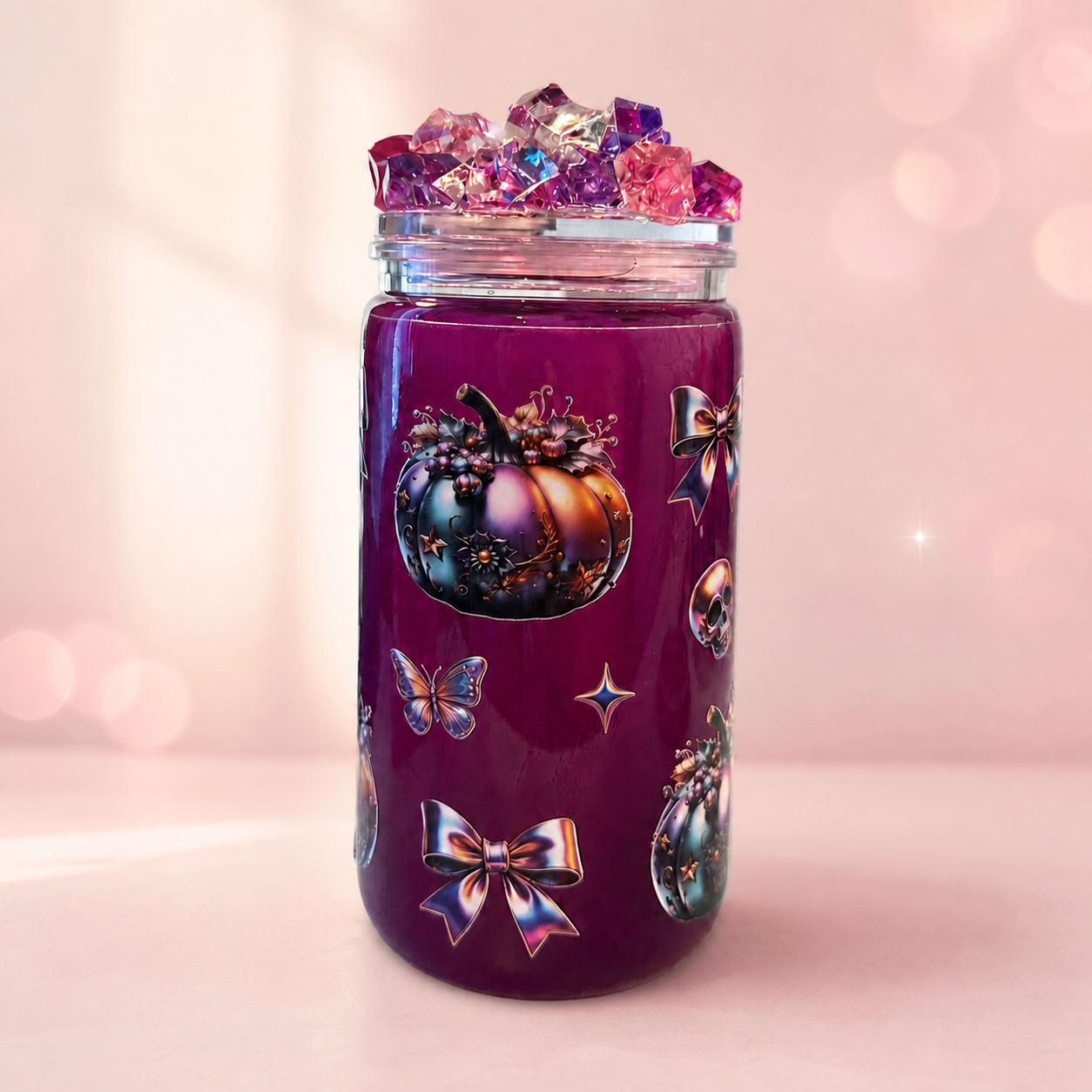Magenta tumbler with decorative pumpkins, bows and crystal-style lid